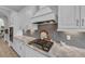 Gourmet kitchen with built-in oven, range, stainless steel appliances, and custom cabinets at 2806 Starwood Ct, Lakewood Ranch, FL 34211