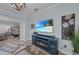 Relaxing living room with a fireplace and TV, a soothing color palette, and access to the main bedroom at 2806 Starwood Ct, Lakewood Ranch, FL 34211