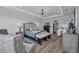 Spacious main bedroom features a tray ceiling, seating area, and ensuite bathroom with vanity at 2806 Starwood Ct, Lakewood Ranch, FL 34211