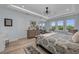 A bright bedroom with a decorative tray ceiling, and plenty of natural light through large windows at 2806 Starwood Ct, Lakewood Ranch, FL 34211