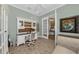 Bright office space featuring wood floors, stylish white shelving, and a comfortable chair at 2806 Starwood Ct, Lakewood Ranch, FL 34211