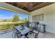 Covered outdoor kitchen and dining area with grill and serene views at 2806 Starwood Ct, Lakewood Ranch, FL 34211