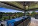 Spacious outdoor living area with a cozy seating area overlooking a lake and a playset at 2806 Starwood Ct, Lakewood Ranch, FL 34211
