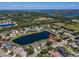 Overhead shot of neighborhood featuring a lake, mature trees, and various residential homes at 2816 88Th E Ave, Parrish, FL 34219