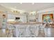 Well-lit kitchen with white cabinetry, a breakfast bar, and tile flooring throughout at 2816 88Th E Ave, Parrish, FL 34219
