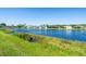 Scenic view of a tranquil pond surrounded by lush green vegetation and several waterfront homes at 2816 88Th E Ave, Parrish, FL 34219