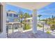 Balcony view overlooking lush landscaping and neighborhood homes with a glimpse of the ocean at 2918 Avenue E, Holmes Beach, FL 34217