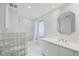 Bright, clean bathroom with glass block shower, tub, and modern vanity at 2918 Avenue E, Holmes Beach, FL 34217