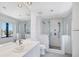 Modern bathroom with glass shower, white tile, and modern fixtures at 2918 Avenue E, Holmes Beach, FL 34217