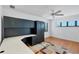 Bedroom with built-in desk and shelving, ample natural light, and ceiling fan at 2918 Avenue E, Holmes Beach, FL 34217