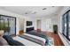 Cozy main bedroom featuring hardwood floors, large windows, and ample closet space at 2918 Avenue E, Holmes Beach, FL 34217