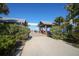 Anna Maria City Pier entrance framed by lush greenery, under a bright blue sky at 2918 Avenue E, Holmes Beach, FL 34217
