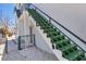 Exterior view of a staircase with green steps alongside a white building, providing access to upper levels at 2918 Avenue E, Holmes Beach, FL 34217