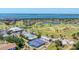 Aerial view displaying the tennis and pickleball courts, swimming pool, clubhouse, and beautifully landscaped surroundings at 3007 Live Oak Ln, Palmetto, FL 34221
