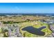 Expansive aerial view of the community showcasing well-manicured golf courses, ponds, and homes with lush surroundings at 3007 Live Oak Ln, Palmetto, FL 34221