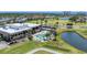 Aerial view of the community clubhouse, pool, and golf course, with attractive landscaping and residences nearby at 3007 Live Oak Ln, Palmetto, FL 34221