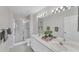 Bright bathroom featuring double sinks, framed mirror and glass enclosed shower at 3007 Live Oak Ln, Palmetto, FL 34221