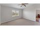 Bright bedroom featuring a ceiling fan, neutral carpeting and a large window for natural light at 3007 Live Oak Ln, Palmetto, FL 34221