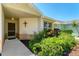 Charming home entrance featuring a decorated door, beautiful plants, and a well maintained walkway at 3007 Live Oak Ln, Palmetto, FL 34221