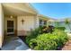 Close-up of a home's front entrance, surrounded by vibrant landscaping at 3007 Live Oak Ln, Palmetto, FL 34221