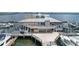 Waterfront building with boat docks offers direct access to the bay and open-air deck at 3007 Live Oak Ln, Palmetto, FL 34221