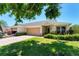 Inviting home with a lush front yard, a two-car garage, and a welcoming entrance at 3007 Live Oak Ln, Palmetto, FL 34221