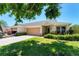 Inviting single-story home featuring a two-car garage, lovely landscaping, and a welcoming entrance at 3007 Live Oak Ln, Palmetto, FL 34221