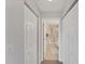 Hallway with linen closets leading to a bathroom with a glass-enclosed shower at 3007 Live Oak Ln, Palmetto, FL 34221