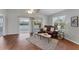 Cozy living room with hardwood floors, a leather sofa, and access to an outdoor patio at 3007 Live Oak Ln, Palmetto, FL 34221