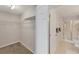 Walk-in closet leading to bathroom with glass-enclosed shower and storage space at 3007 Live Oak Ln, Palmetto, FL 34221