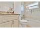 Renovated bathroom with a tiled shower, soaking tub, and updated vanity with stone countertops at 3453 Dryden St, North Port, FL 34288