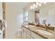 Bathroom featuring a granite-topped, double sink vanity and tile floors at 3453 Dryden St, North Port, FL 34288