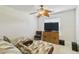 Cozy bedroom featuring a wooden cabinet, modern TV, and stylish chaise lounges for relaxation at 3453 Dryden St, North Port, FL 34288