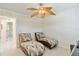 Bright bedroom with two chaise lounges, tile flooring and a unique leaf-shaped ceiling fan at 3453 Dryden St, North Port, FL 34288