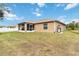 Exterior view of the home featuring the screened lanai and landscaping at 3453 Dryden St, North Port, FL 34288