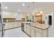 Spacious kitchen with granite countertops, stainless steel appliances, a central island, and a connected dining area at 3453 Dryden St, North Port, FL 34288