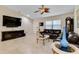 Comfortable living room with tile floors, vaulted ceilings, flat-screen tv, and two plush leather sofas at 3453 Dryden St, North Port, FL 34288