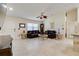 Bright living room boasting tile floors, vaulted ceilings, a ceiling fan, and comfortable dark-brown leather furniture at 3453 Dryden St, North Port, FL 34288