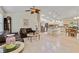 Open-concept living space with tile floors, vaulted ceilings, modern ceiling fan, and seamless flow to kitchen at 3453 Dryden St, North Port, FL 34288