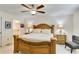 Spacious main bedroom features a decorative bedframe, ceiling fan, and tiled floors at 3453 Dryden St, North Port, FL 34288