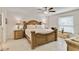 Spacious main bedroom features a decorative bedframe, ceiling fan, and tiled floors at 3453 Dryden St, North Port, FL 34288