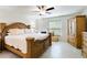 Spacious main bedroom features a decorative bedframe, ceiling fan, and tiled floors at 3453 Dryden St, North Port, FL 34288