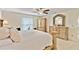 Spacious main bedroom features a decorative bedframe, ceiling fan, and tiled floors at 3453 Dryden St, North Port, FL 34288
