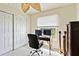 Well-lit home office featuring a desk, rolling chair, and decorative leaf ceiling fan at 3453 Dryden St, North Port, FL 34288