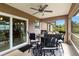 Cozy screened-in patio with a ceiling fan and dining set, perfect for outdoor entertaining at 3453 Dryden St, North Port, FL 34288