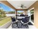 Charming screened-in patio with a ceiling fan and dining set, ideal for enjoying the outdoors at 3453 Dryden St, North Port, FL 34288
