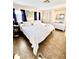 Cozy bedroom features white linens, blue curtains, and ample natural light at 36 N Starboard Dr, Venice, FL 34285