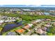 A high-angle view displays numerous houses nestled amid lush foliage and serene waters in a suburban setting at 4180 Via Mirada, Sarasota, FL 34238