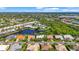 Panoramic aerial view of a community with homes surrounding a serene pond at 4180 Via Mirada, Sarasota, FL 34238