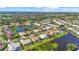 Beautiful aerial shot of homes bordering a tranquil lake in a scenic residential area at 4180 Via Mirada, Sarasota, FL 34238